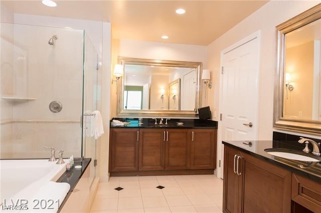 bathroom featuring tile patterned flooring, vanity, and separate shower and tub