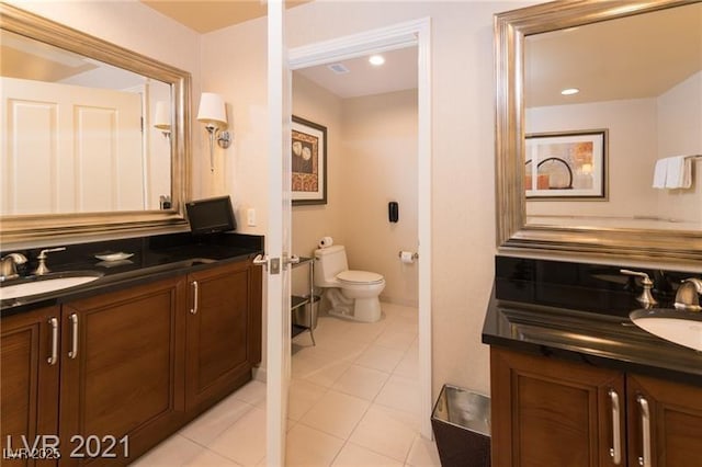 bathroom with tile patterned floors, vanity, and toilet