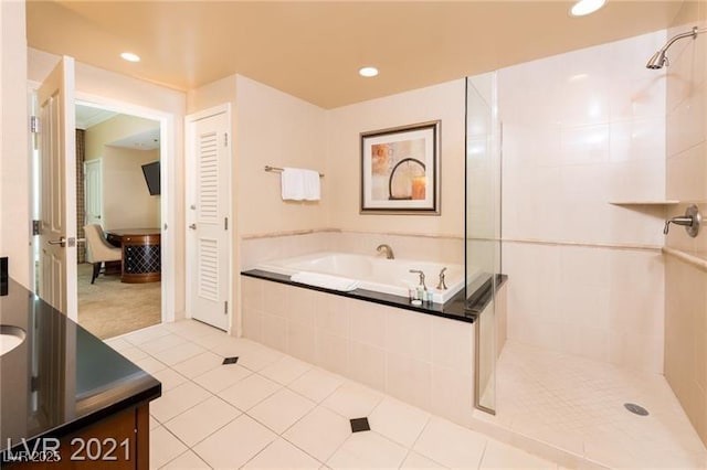 bathroom featuring tile patterned flooring and plus walk in shower