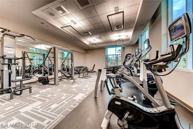 exercise room with a drop ceiling