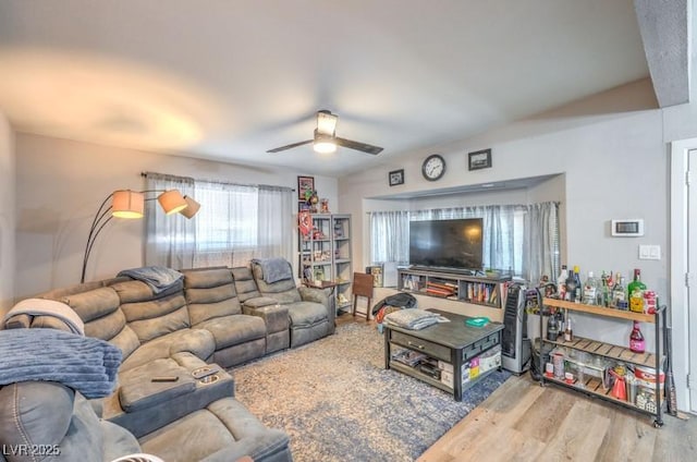 living room featuring hardwood / wood-style floors and ceiling fan