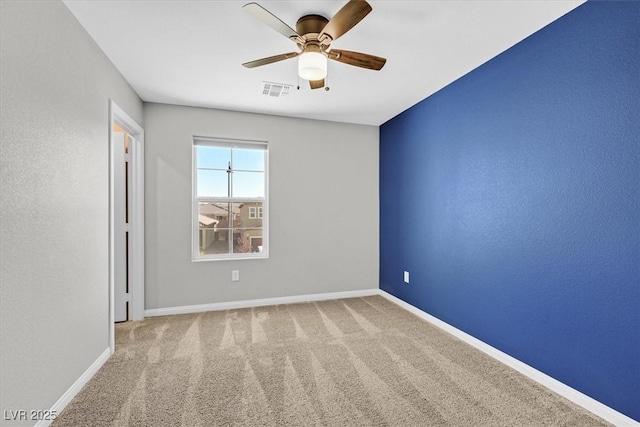 carpeted empty room featuring ceiling fan