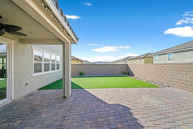 view of patio / terrace featuring ceiling fan