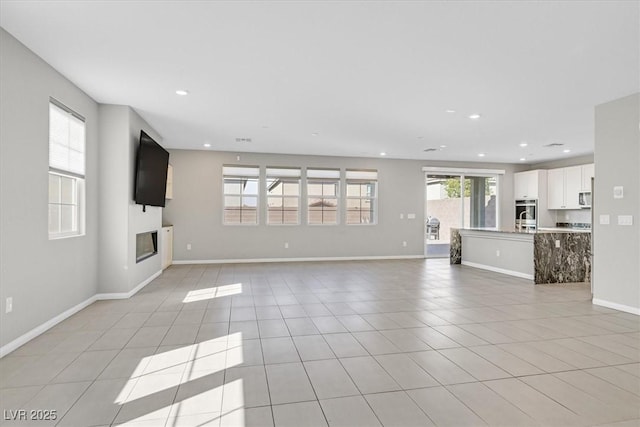 unfurnished living room with light tile patterned floors