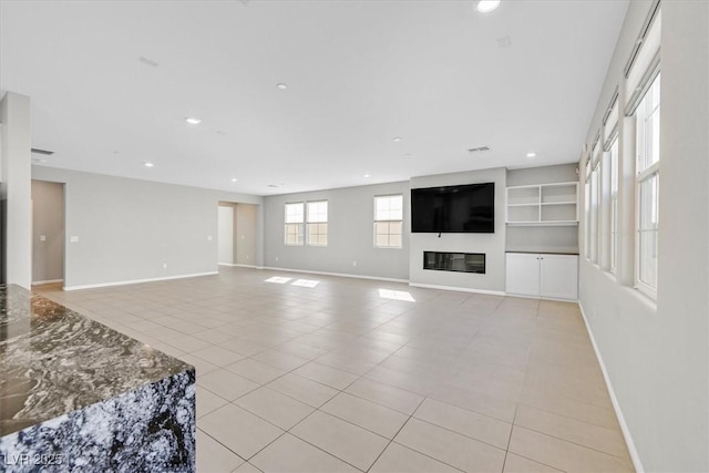 unfurnished living room featuring light tile patterned flooring