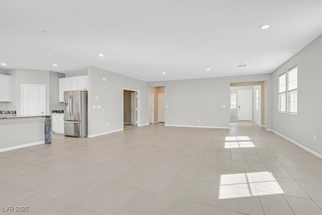 unfurnished living room featuring light tile patterned floors