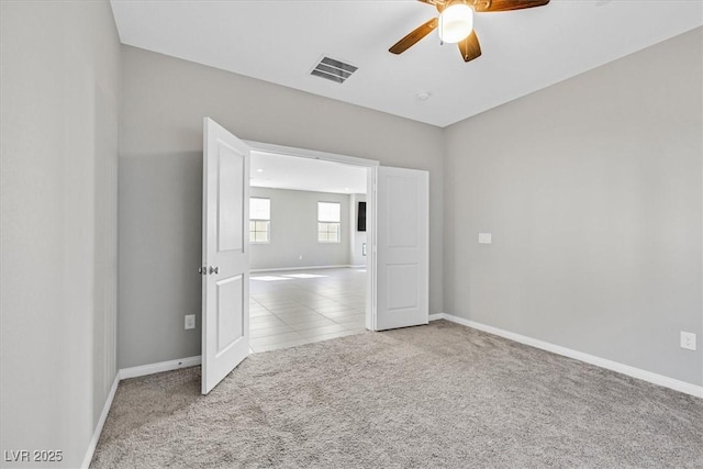 carpeted spare room with ceiling fan