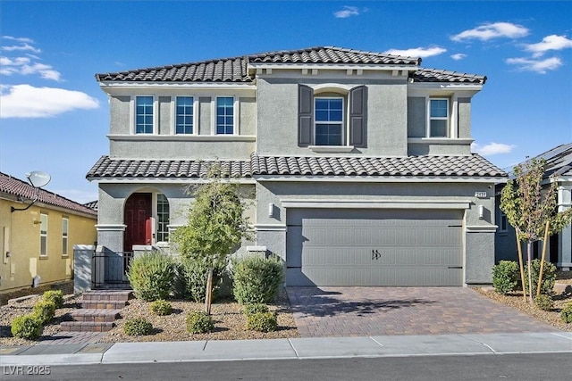 mediterranean / spanish-style home with a garage