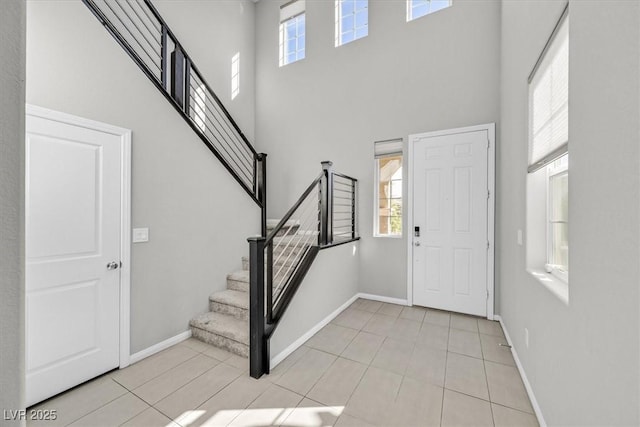 entrance foyer featuring light tile patterned floors and a high ceiling