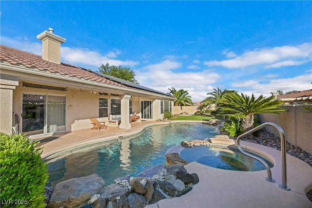 view of pool with an in ground hot tub and a patio