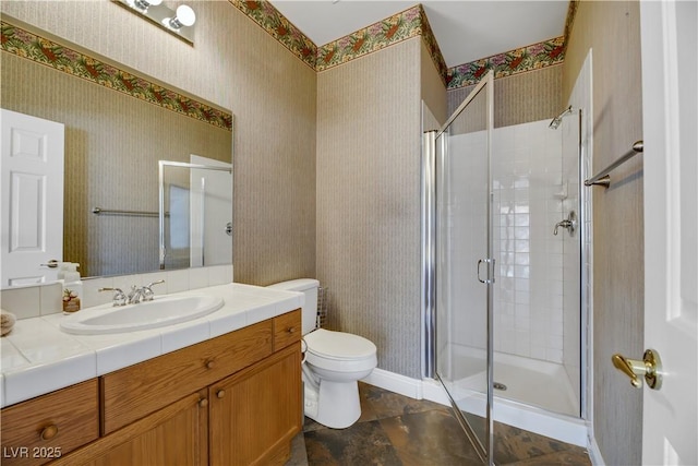 bathroom with vanity, toilet, and walk in shower