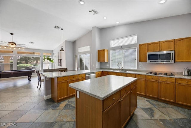 kitchen with a center island, billiards, hanging light fixtures, and appliances with stainless steel finishes