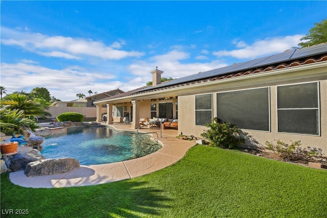 view of pool featuring a yard, an outdoor living space, pool water feature, and a patio