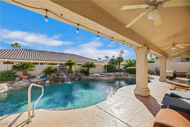 view of swimming pool with a patio area, ceiling fan, pool water feature, and an in ground hot tub