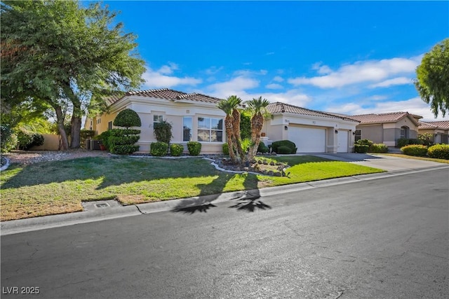 mediterranean / spanish-style house featuring a front yard and a garage