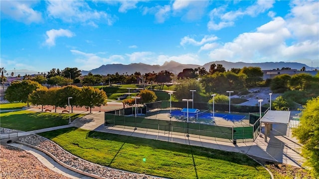 surrounding community with a mountain view and tennis court