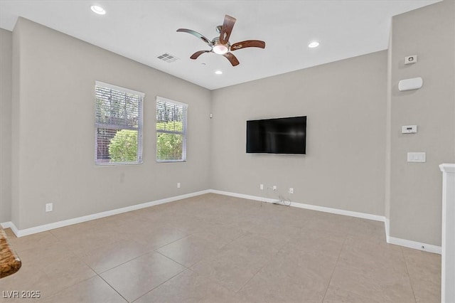 spare room featuring ceiling fan and light tile patterned flooring