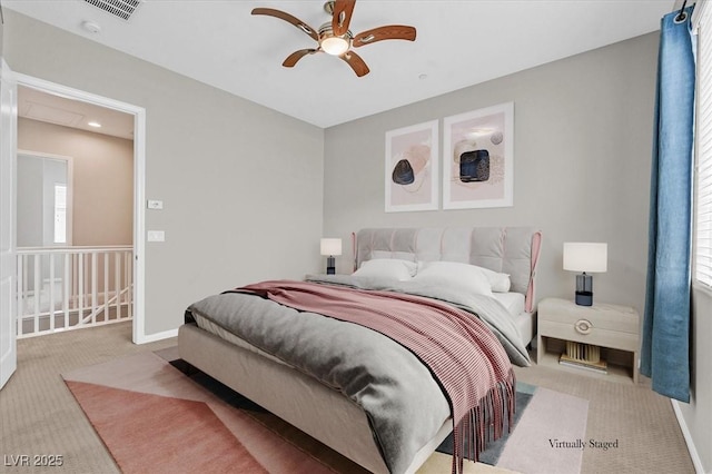 carpeted bedroom with multiple windows and ceiling fan