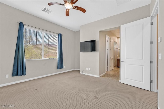 unfurnished room featuring light carpet and ceiling fan