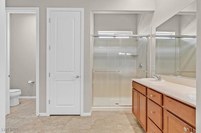 10375 Pescado Ln, Las Vegas, NV 89135 - bathroom featuring a stall shower, double vanity, toilet, tile patterned floors, and baseboards