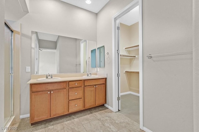 bathroom with a shower with door and vanity