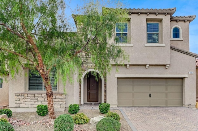 mediterranean / spanish-style home with a garage