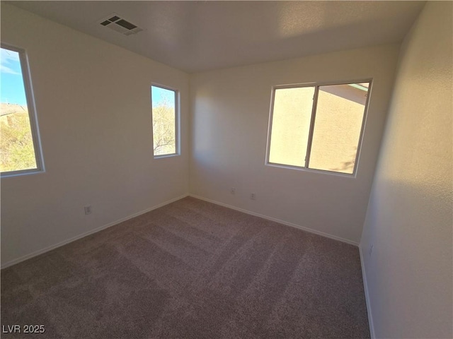 unfurnished room with dark carpet