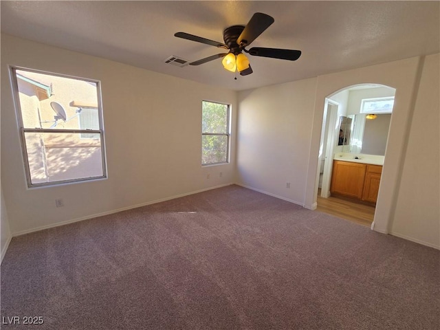 unfurnished room with ceiling fan and light colored carpet