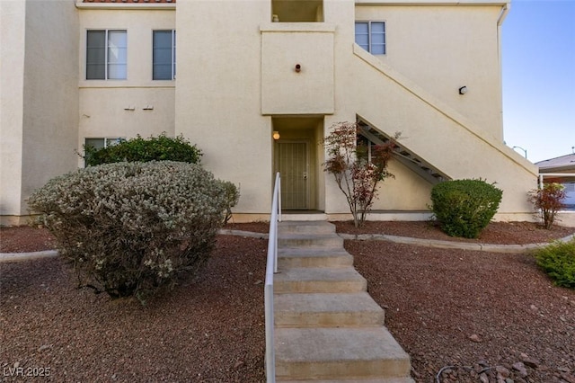 entrance to property with stucco siding