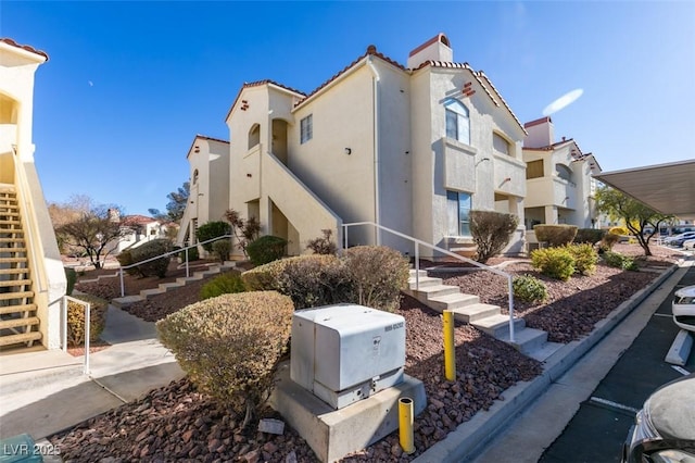 view of building exterior with stairway and a residential view