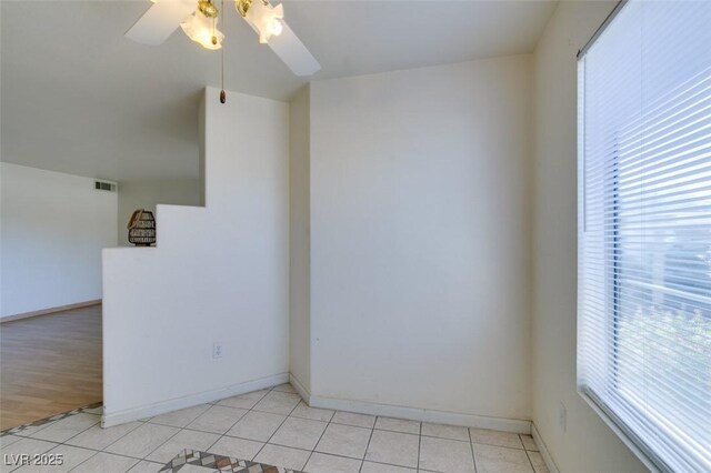 unfurnished room with light tile patterned floors, ceiling fan, and a healthy amount of sunlight