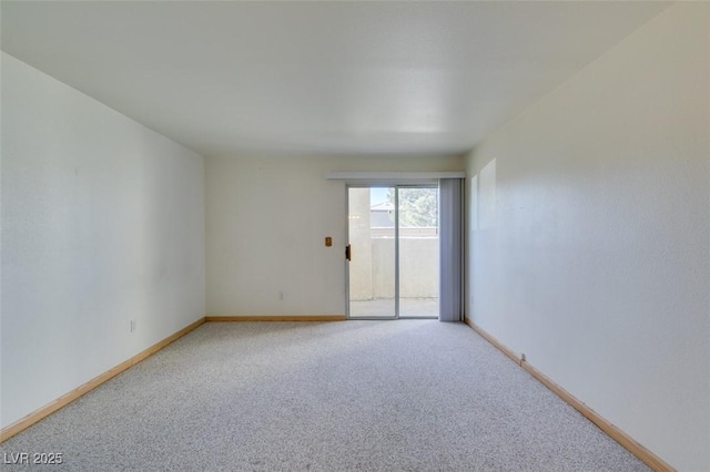 spare room with carpet floors and baseboards