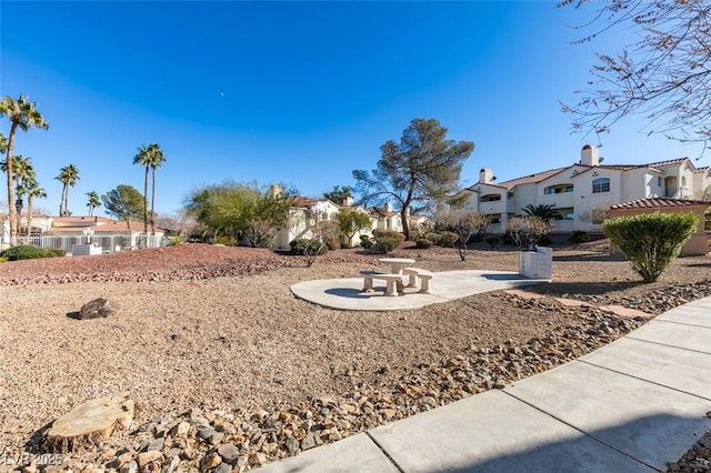 view of yard with a residential view and a patio area