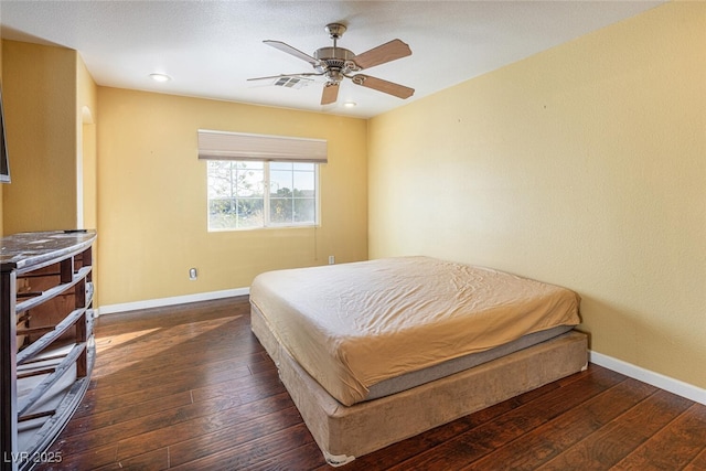 bedroom with ceiling fan and dark hardwood / wood-style floors