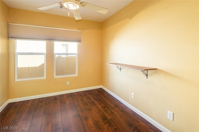 empty room with dark hardwood / wood-style floors and ceiling fan