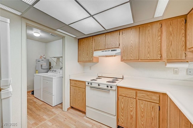 kitchen with a drop ceiling, electric water heater, light hardwood / wood-style flooring, washer and clothes dryer, and white stove