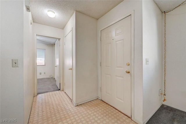 hallway featuring a textured ceiling