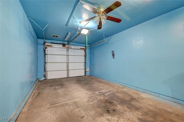 garage with a garage door opener and ceiling fan