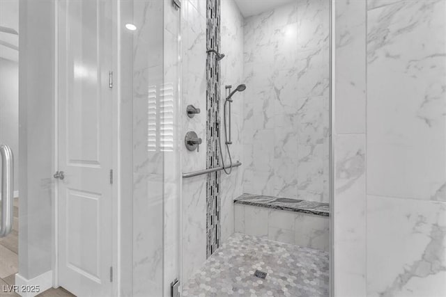 bathroom with a tile shower