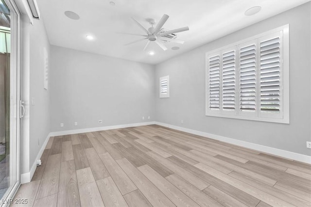 empty room featuring ceiling fan and light wood-type flooring