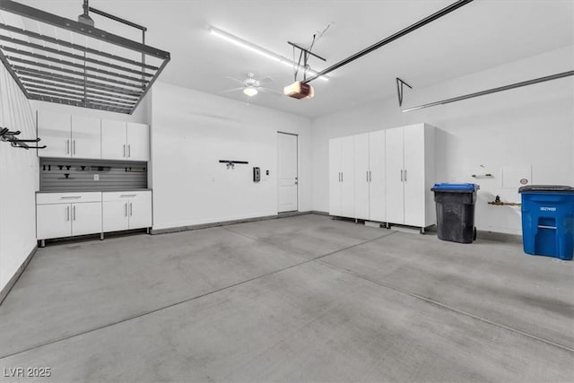 garage featuring ceiling fan and a garage door opener