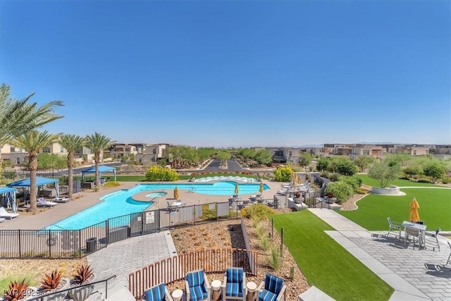 view of pool featuring a patio area and a yard