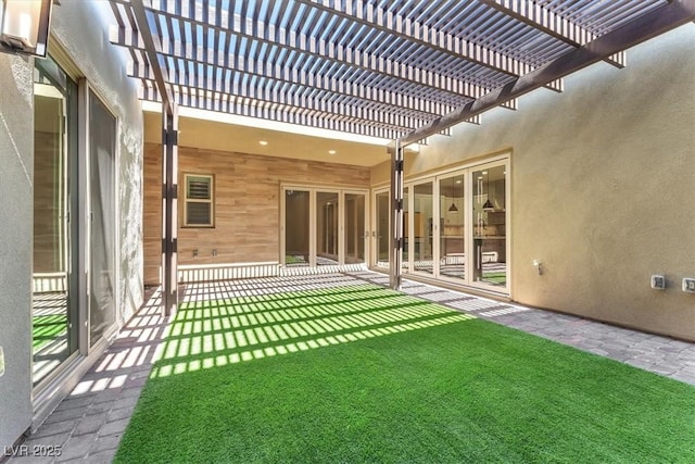 exterior space with a pergola and a lawn