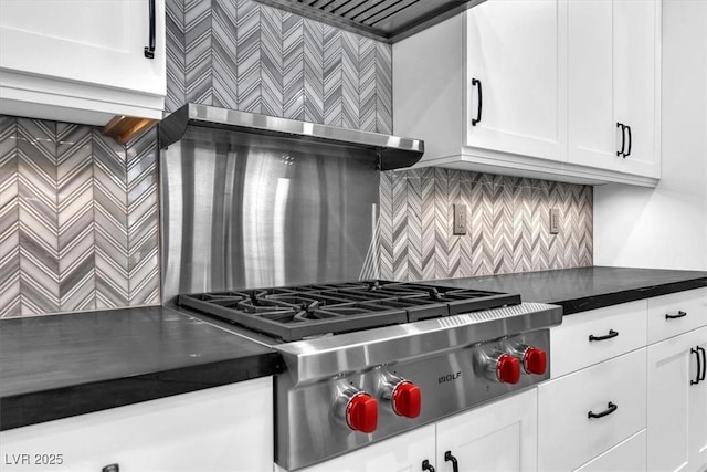 kitchen with white cabinets, stainless steel gas cooktop, and tasteful backsplash