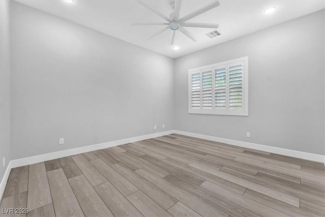 empty room with ceiling fan and light wood-type flooring