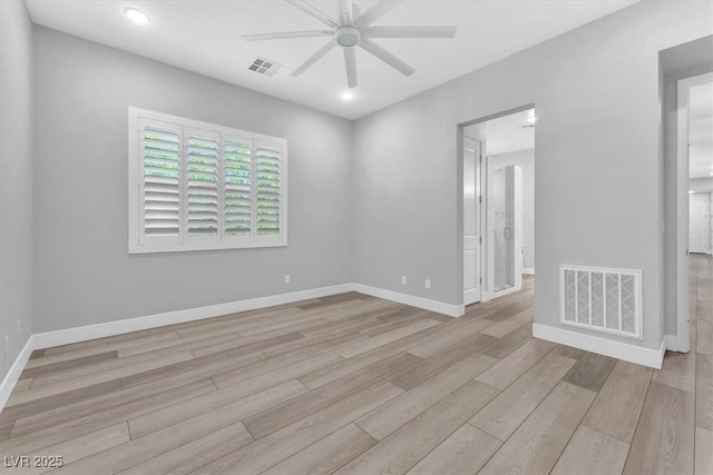 empty room with ceiling fan and light hardwood / wood-style flooring