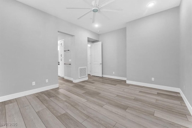 spare room featuring ceiling fan and light hardwood / wood-style floors