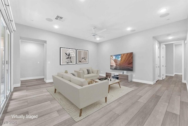 living room featuring ceiling fan and light wood-type flooring