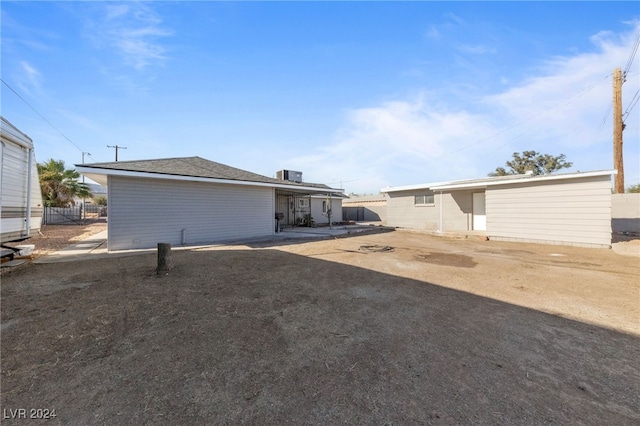 rear view of property featuring cooling unit