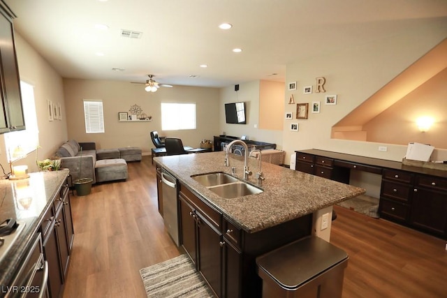 kitchen featuring dishwasher, sink, ceiling fan, an island with sink, and dark brown cabinetry